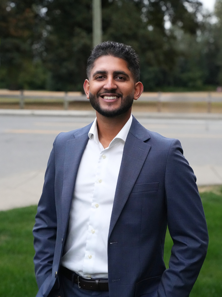 Portrait of Arsh Kaler, Abbotsford School Trustee, outdoors in a navy suit